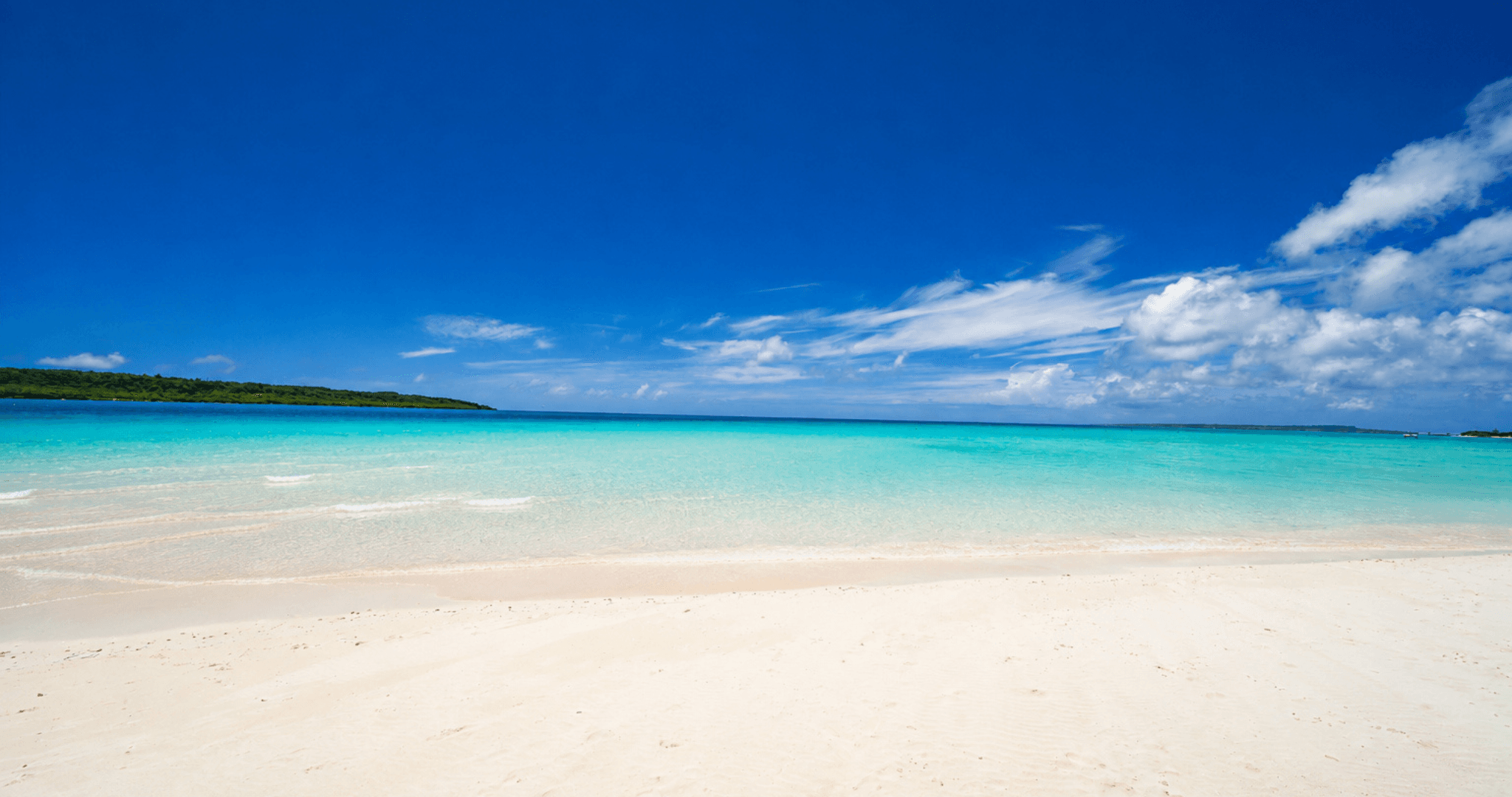 A beach of white sand and clear shallow water